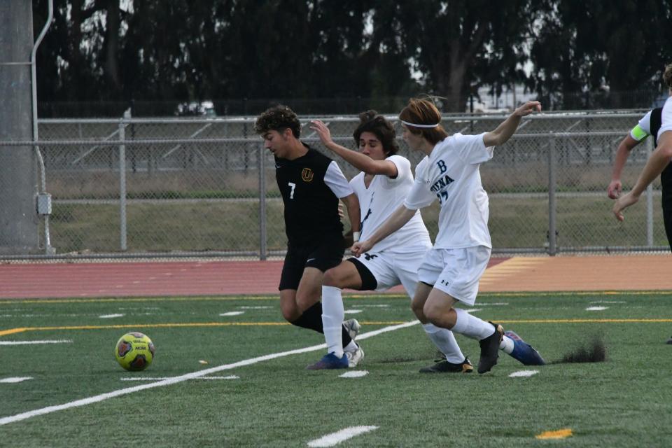 Oxnard's Pabel Ayala fights off two Buena defenders during their Channel League match on Saturday. The Yellowjackets won 3-0 to improve to 7-0-3 overall and 5-0-0 in league.