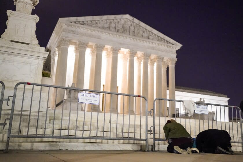 A crowd gathers outside the Supreme Court on Monday night after a purported leak says that Roe vs. Wade will be overturned on May 2, 2022.