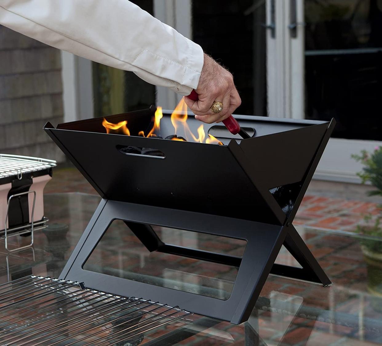 <p><a href="https://www.amazon.com/Fire-Sense-Notebook-Charcoal-Grill/dp/B001OC5PYY/ref=sr_1_4?tag=syn-yahoo-20&ascsubtag=%5Bartid%7C2139.a.44376636%5Bsrc%7Cyahoo-us" rel="nofollow noopener" target="_blank" data-ylk="slk:Shop Now;elm:context_link;itc:0;sec:content-canvas" class="link rapid-noclick-resp">Shop Now</a></p><p>Notebook Charcoal BBQ Grill</p><p>$24.58</p><p>amazon.com</p>