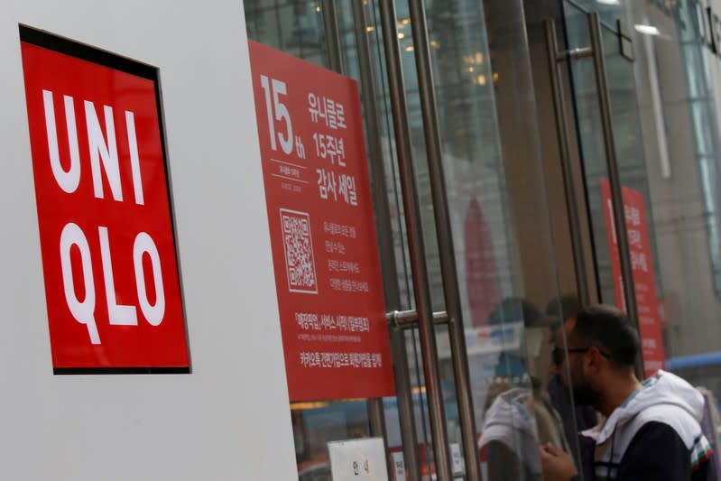 A man walks past the logo of Uniqlo at Myeongdong shopping district in Seoul