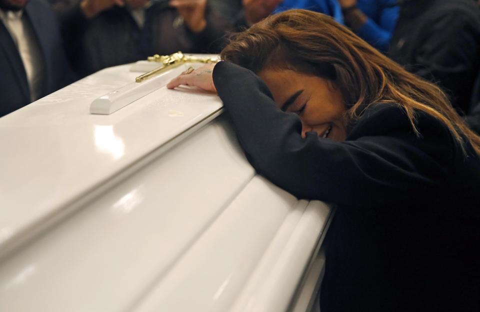 The sister of Elias Wardini, of Elias Wardini, a Lebanese man who was killed in the New Year's Eve Istanbul nightclub attack, mourns over his coffin, at a church, in Beirut, Lebanon, Tuesday, Jan. 3, 2017. Three Lebanese citizens were killed in the shooting and four injured. (AP Photo/Hussein Malla)