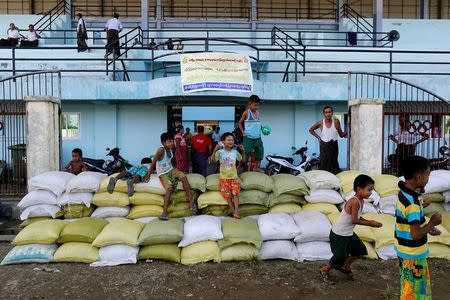 Rakhine Buddhists who fled from recent violence in Maungdaw pass their time in a temporary shelter at a stadium in Sittwe, Myanmar, October 25, 2016. Picture taken October 25, 2016. REUTERS/Soe Zeya Tun