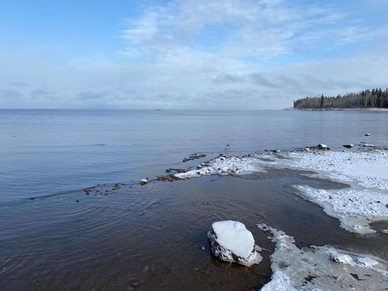 A sandbar in the distance is where ships have gotten stuck on Great Slave Lake near the mouth of the Hay River in Hay River, N.W.T., in 2022. Dredging work has been underway this summer to ensure there's a deep enough channel for boats to navigate. (Emily Blake/The Canadian Press - image credit)