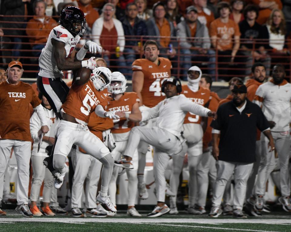 Texas cornerback Malik Muhammad intercepts a Texas Tech pass during the Longhorns' win in the regular-season finale. The freshman made his first career start the following week in the Big 12 championship game win over Oklahoma State.