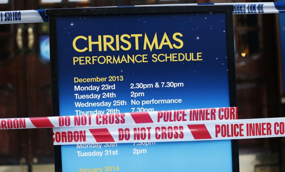 Police tape is wrapped around a notice board outside the Apollo theatre on the morning after part of it's ceiling collapsed on spectators as they watched a performance, in central London