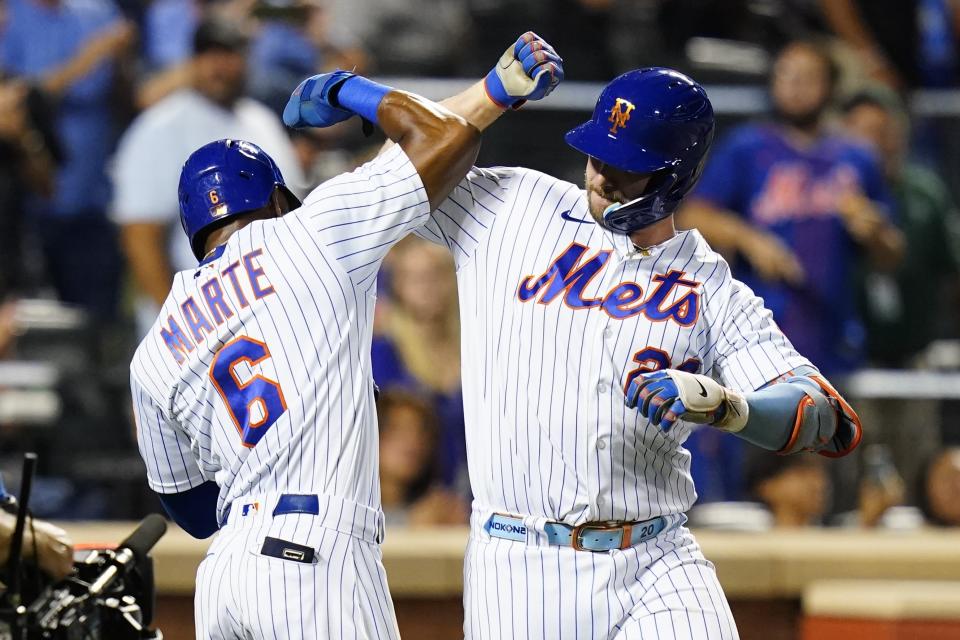 New York Mets' Pete Alonso, right, celebrates with teammate Starling Marte after they scored on a two-run home run by Alonso during the third inning of a baseball game against the Colorado Rockies, Thursday, Aug. 25, 2022, in New York. (AP Photo/Frank Franklin II)