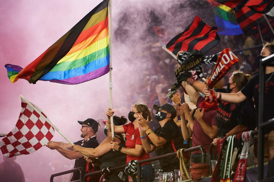 Portland Thorns fans — known as the Rose City Riveters — regularly fly pride flags at NWSL games.