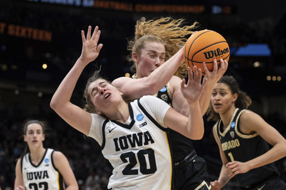 Colorado guard Frida Formann and Iowa guard Kate Martin (20) compete for a rebound during the first half of a Sweet 16 college basketball game in the women's NCAA tournament Friday, March 24, 2023, in Seattle. (AP Photo/Stephen Brashear)