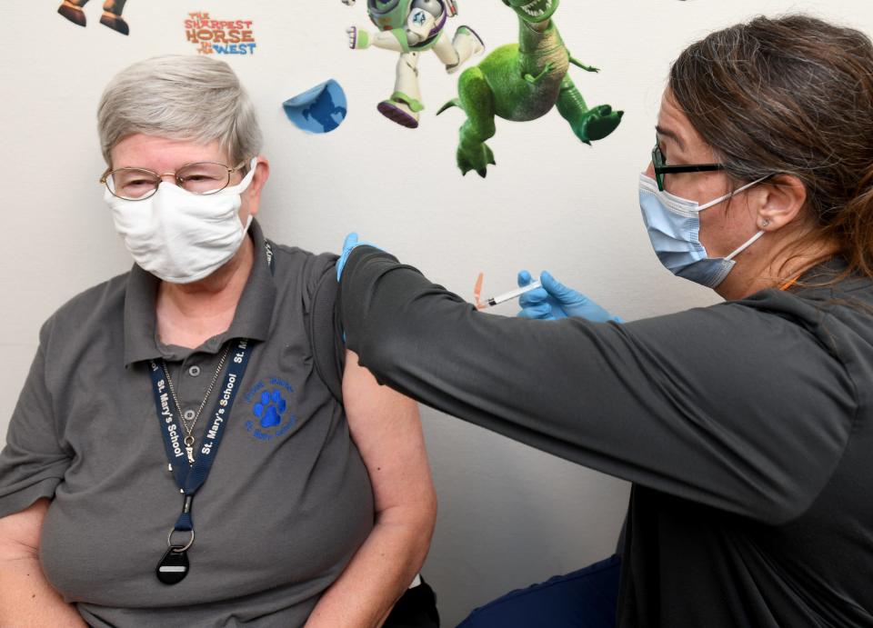 Sister Kathy Longheier with St. Mary's School receives a booster shot from Nurse Christine Gogerty during a Covid-10 vaccine booster clinic at Massillon Health Department.  Tuesday, October 12, 2021. 