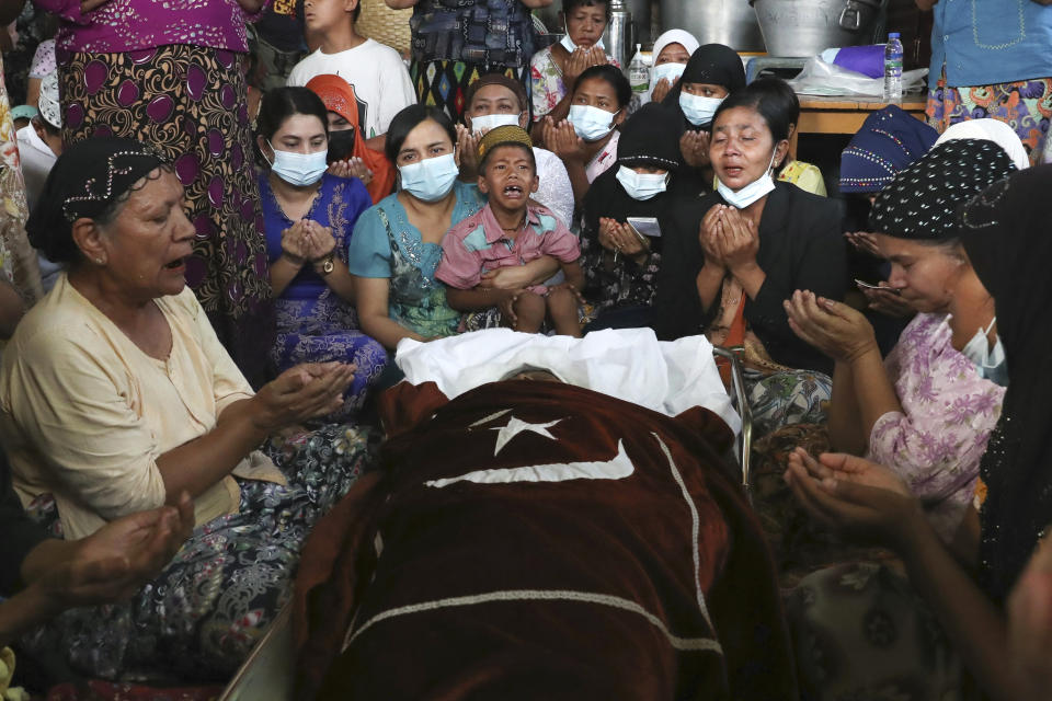 Family and relatives pray next to the body of the Muslim woman who her family said was killed by the army Sunday, during her funeral service in Mandalay, Myanmar, Monday, March 1, 2021. Defiant crowds returned to the streets of Myanmar's biggest city of Yangon on Monday, determined to continue their protests against the military's seizure of power a month ago, despite security forces having killed at least 18 people around the country just a day earlier. (AP Photo)