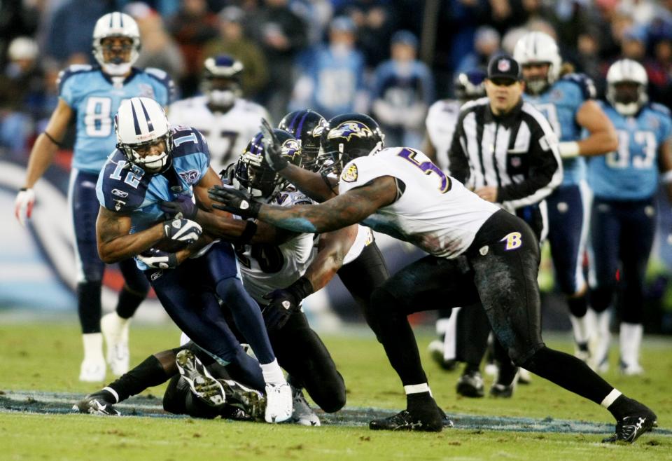 Tennessee Titans receiver Justin Gage (12) is tackled by Baltimore Ravens defenders Ed Reed, Ray Lewis and Terrel Suggs in the second quarter of the AFC Divisional playoff game at LP Field in Nashville Jan. 10, 2009.