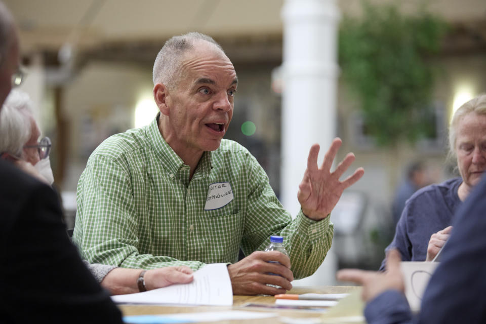 Democrat Paddy McGuire, incumbent Mason County auditor, talks with voters during before a "candidate speed-dating" style forum, Thursday, Oct. 13, 2022, in Shelton, Wash. (AP Photo/John Froschauer)