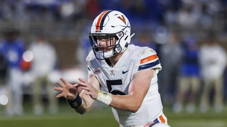 Virginia&#39;s Brennan Armstrong (5) takes a snap during the first half of an NCAA college football game against Duke in Durham, N.C., Saturday, Oct. 1, 2022. (AP Photo/Ben McKeown)