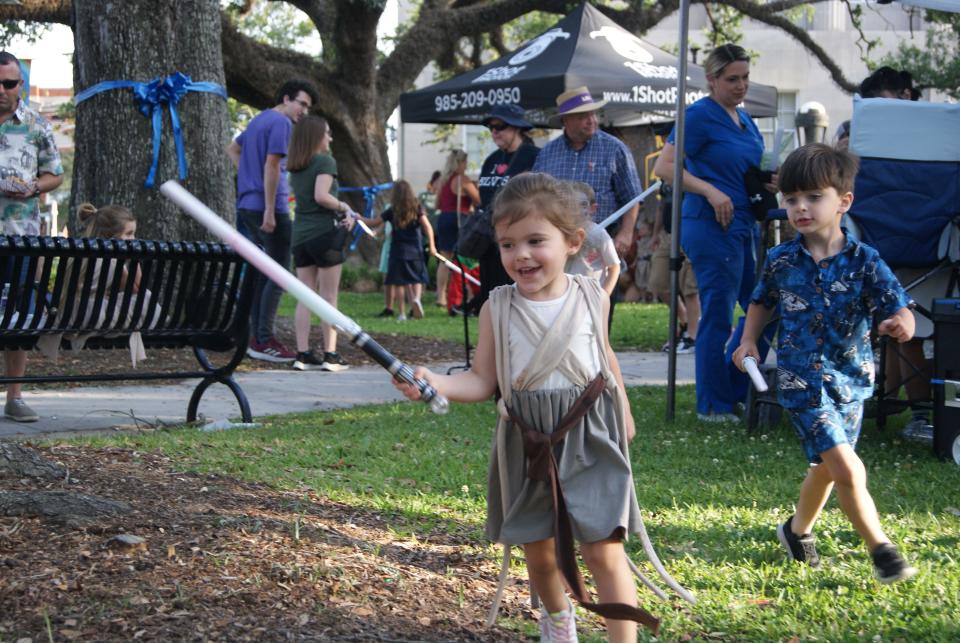 Allison and her brother Evan Roussel play in the Courthouse Square during the Star Wars themed May the Fourth Be With You event, Thursday, May 4.