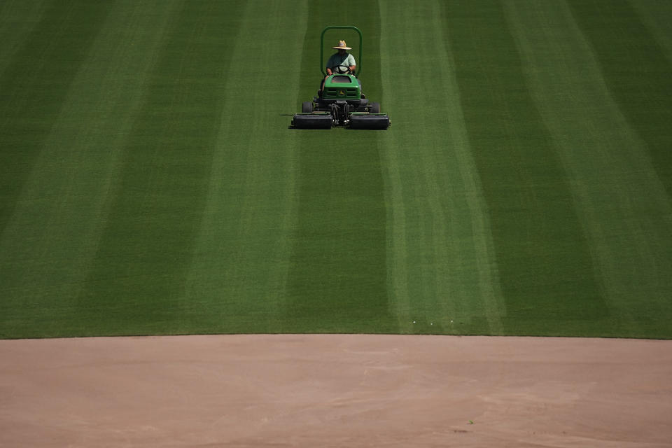 A grounds keeper tends to the field, mowing the outfield grass at Rickwood Field, Monday, June 10, 2024, in Birmingham, Ala. Rickwood Field, known as one of the oldest professional ballpark in the United States and former home of the Birmingham Black Barons of the Negro Leagues, will be the site of a special regular season game between the St. Louis Cardinals and San Francisco Giants on June 20, 2024. (AP Photo/Brynn Anderson)