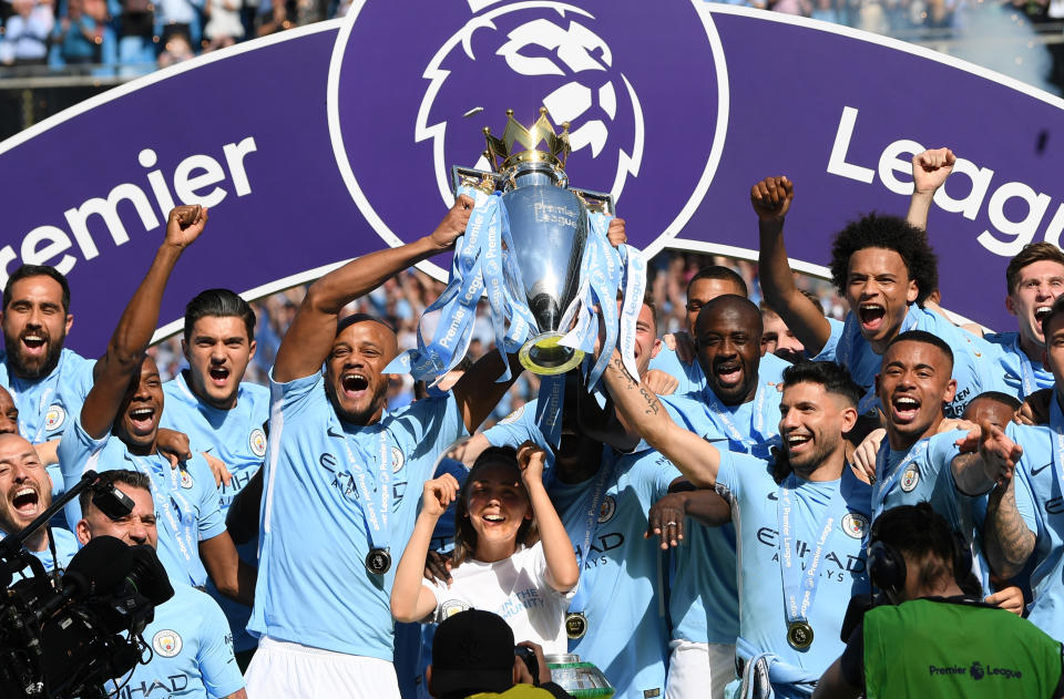 MANCHESTER, ENGLAND - MAY 06:  Vincent Kompany of Manchester City lifts the Premier League Trophy as Manchester City celebrate winning the Premier League after the Premier League match between Manchester City and Huddersfield Town at Etihad Stadium on May 6, 2018 in Manchester, England.  (Photo by Shaun Botterill/Getty Images)