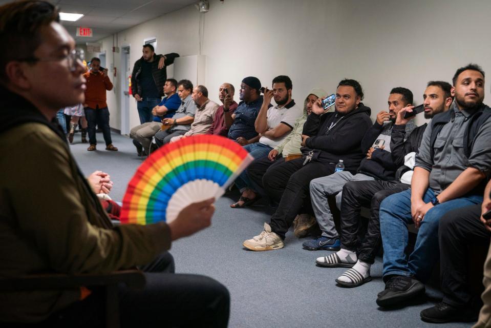 People overflow into a hallway to listen to public comment before a vote about banning the LGBTQ Pride flag on government buildings and city property, including other flags representing racial and political issues, during a city council meeting at Hamtramck City Hall on Tuesday, June 13, 2023.