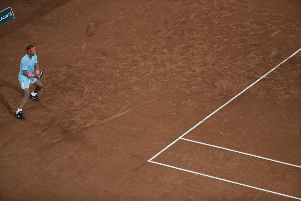 Spain's Rafael Nadal waits for Italy's Stefano Travaglia's serve, in his usual position far from the baseline in the third round match of the French Open tennis tournament at the Roland Garros stadium in Paris, France, Friday, Oct. 2, 2020. Nadal's position leaves him vulnerable to underarm serves, used by some players at this year's French Open, including by the man Nadal beat in the second round. There is some discussion about whether such serves are a legitimate tactic and Nadal thinks they are fine as long as they are used to try to win a point and not to show disrespect to an opponent. (AP Photo/Alessandra Tarantino)