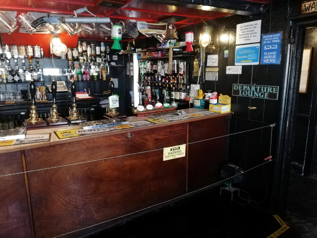 A pub run by a farmer is making sure people social distance - by installing an ELECTRIC FENCE at the bar. See SWNS story SWPLfence. The Star Inn has installed a barrier normally used to deter CATTLE to stop punters crowding while getting a pint. It reopened along with boozers across England after lockdown but said they were worried about drinkers not maintaining social distancing. To help protect his staff, landlord Johnny McFadden, who is also a farmer, decided to draw on his knowledge and went to his farm to get some equipment.