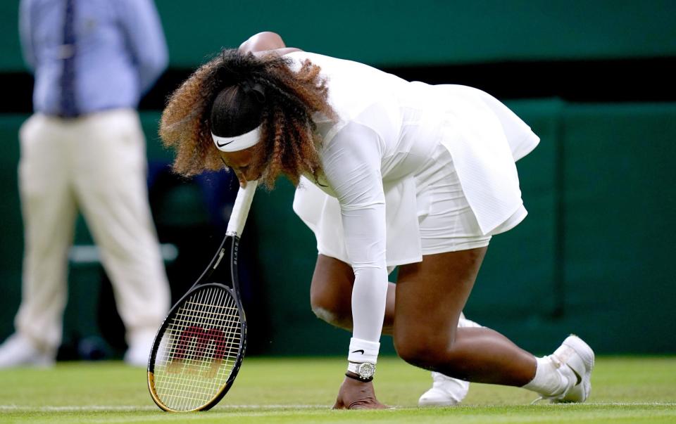 Serena Williams goes down injured during her first round ladies' singles match against Aliaksandra Sasnovich on centre court on day two of Wimbledon at The All England Lawn Tennis and Croquet Club, - PA