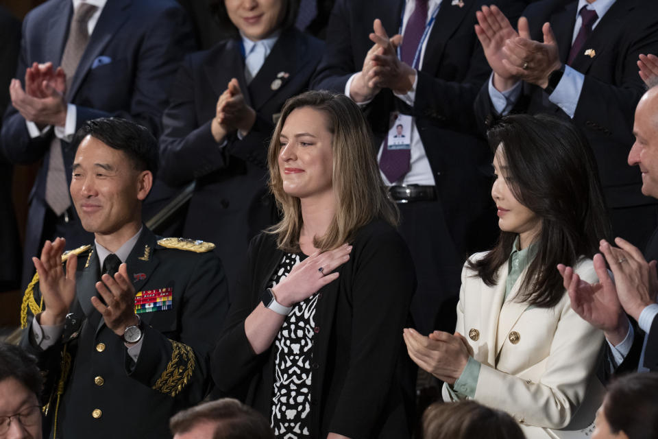 Dayne Weber, second from left, the granddaughter of Col. William Weber a Korean War veteran who fought in the battle for Hill 324, stands as South Korea's President Yoon Suk Yeol introducers her during his address to a joint meeting of Congress, Thursday, April 27, 2023, in Washington. (AP Photo/Alex Brandon)