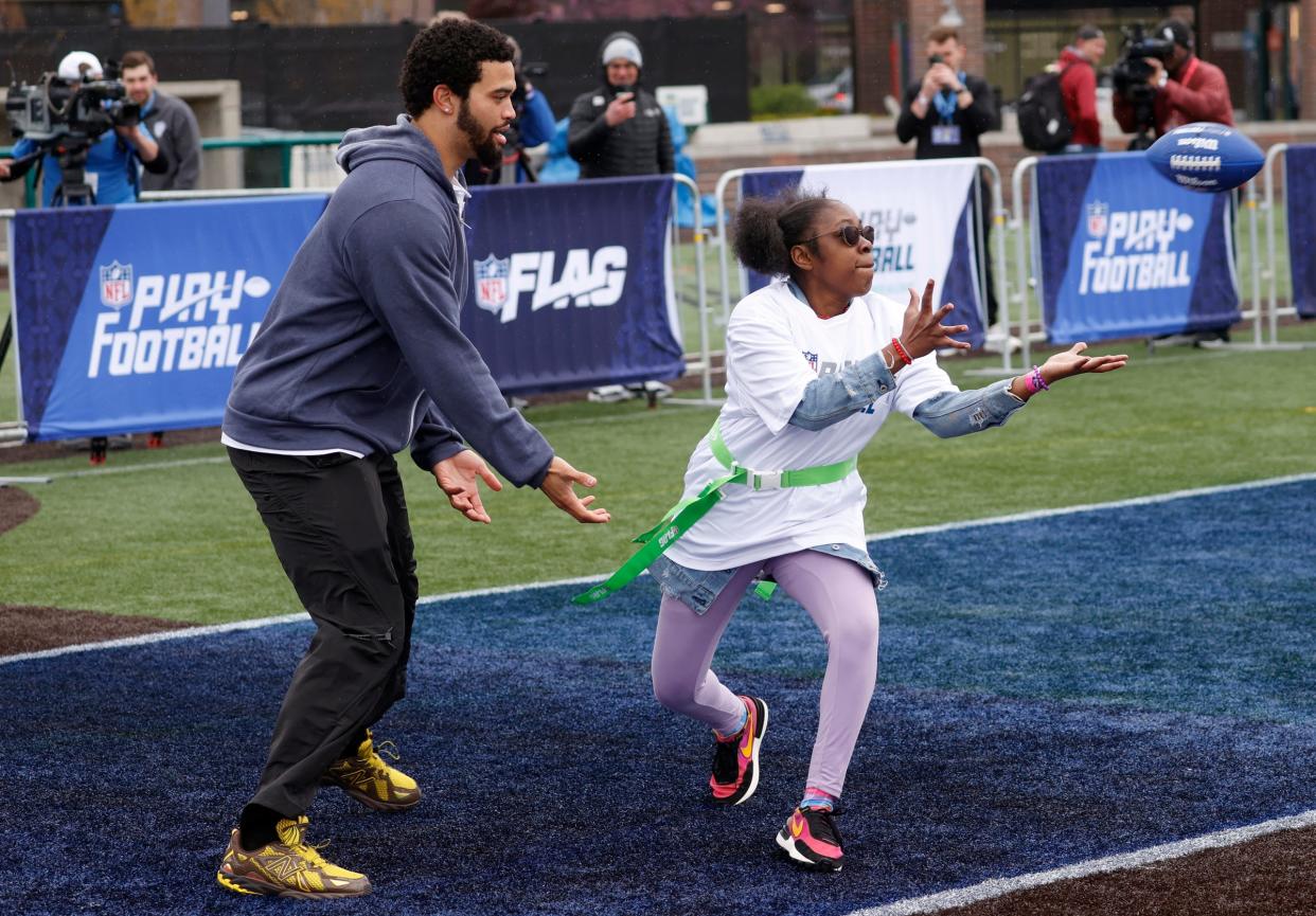 USC quarterback Caleb Williams, who is expected to be the first pick in this year's NFL draft plays defense, as Constance Fullmore, 21, eyes the football and catches it in the end zone during drills at the NFL Play Football Prospect Clinic with Special Olympics athletes and 13 of the 2024 NFL draft prospects at the Corner Ballpark in Detroit on Wednesday, April 24, 2024.