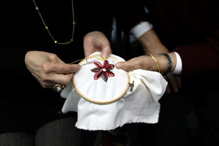 Women cross-stitch during a Christmas workshop to teach embroidery and handicrafts in the northern Israeli city of Nazareth, December 6, 2018. REUTERS/Ammar Awad