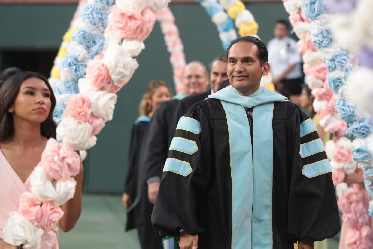 Dr. Edwin Gomez enters the Coachella Valley High School commencement ceremony, Indian Wells, Calif., May 29, 2019.