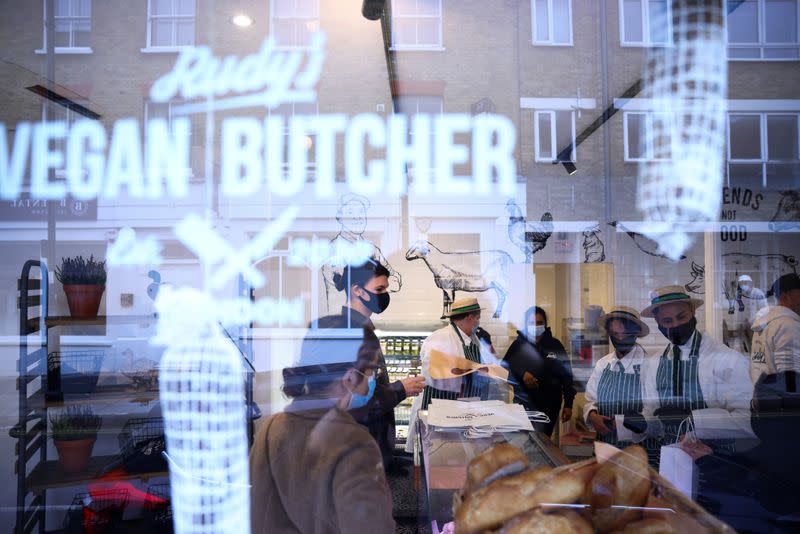 Customers are served inside 'Rudy's Vegan Butcher' shop, amid the coronavirus (COVID-19) outbreak, in London