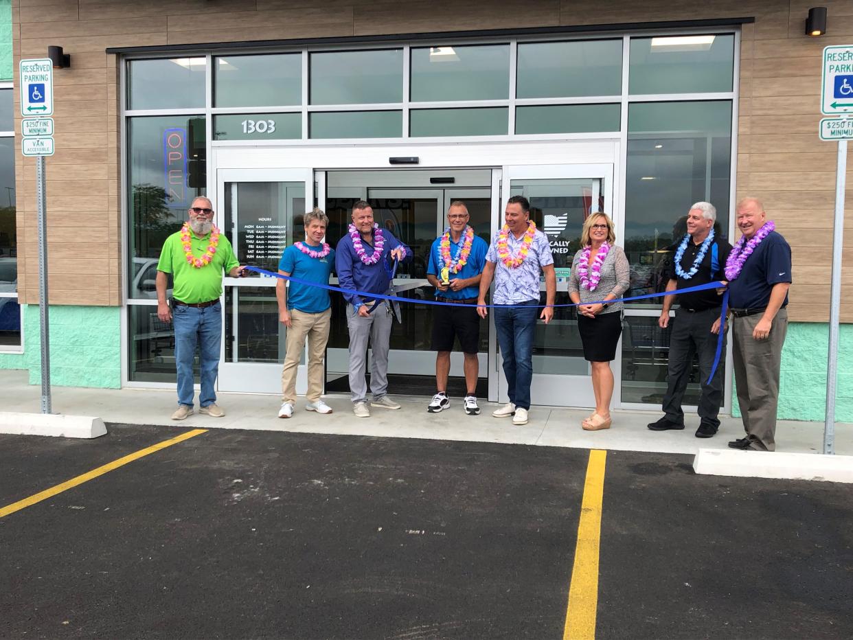 Big Kahuna Ozone Laundry manager J.D. Williamson cuts the ribbon during a ceremony Friday afternoon at the new laundry facility, 1303 Log Pond Drive, Newark, just south of the North 21st Street Walmart. Big Kahuna seeks to modernize the laundry experience for customers by offering free Wi-Fi, accepting credit cards and more.