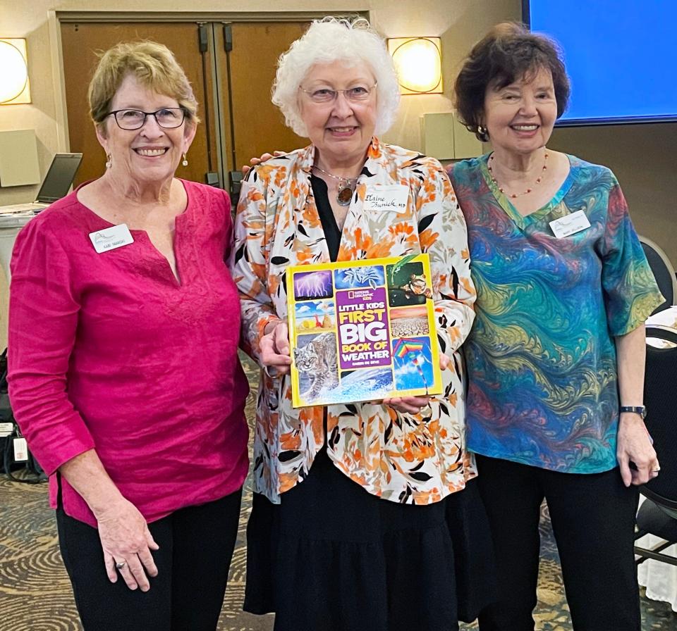 Physician Elaine Bunick, center, signed a book to be donated to the Oak Ridge Preschool.The title is National Geographic Kids’ “Little Kids First Big Book of Weather” by Karen de Seve. With her are Altrusa members Kari Iwanski, left, and Mary Jellison, right.