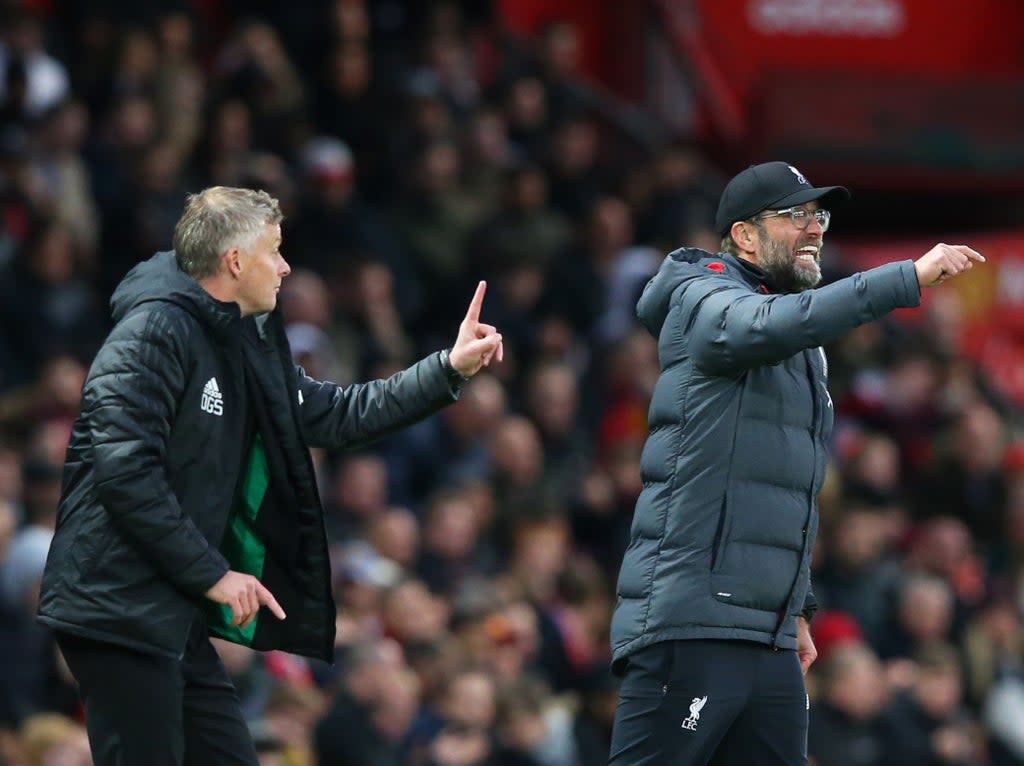 Manchester United coach Ole Gunnar Solskjaer (left) and Liverpool manager Jurgen Klopp (Getty Images)