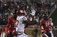 Oklahoma wide receiver Marvin Mims Jr. (17) catches a touchdown pass against Texas Tech during the first half of an NCAA college football game Saturday, Nov. 26, 2022, in Lubbock, Texas. (AP Photo/Justin Rex)