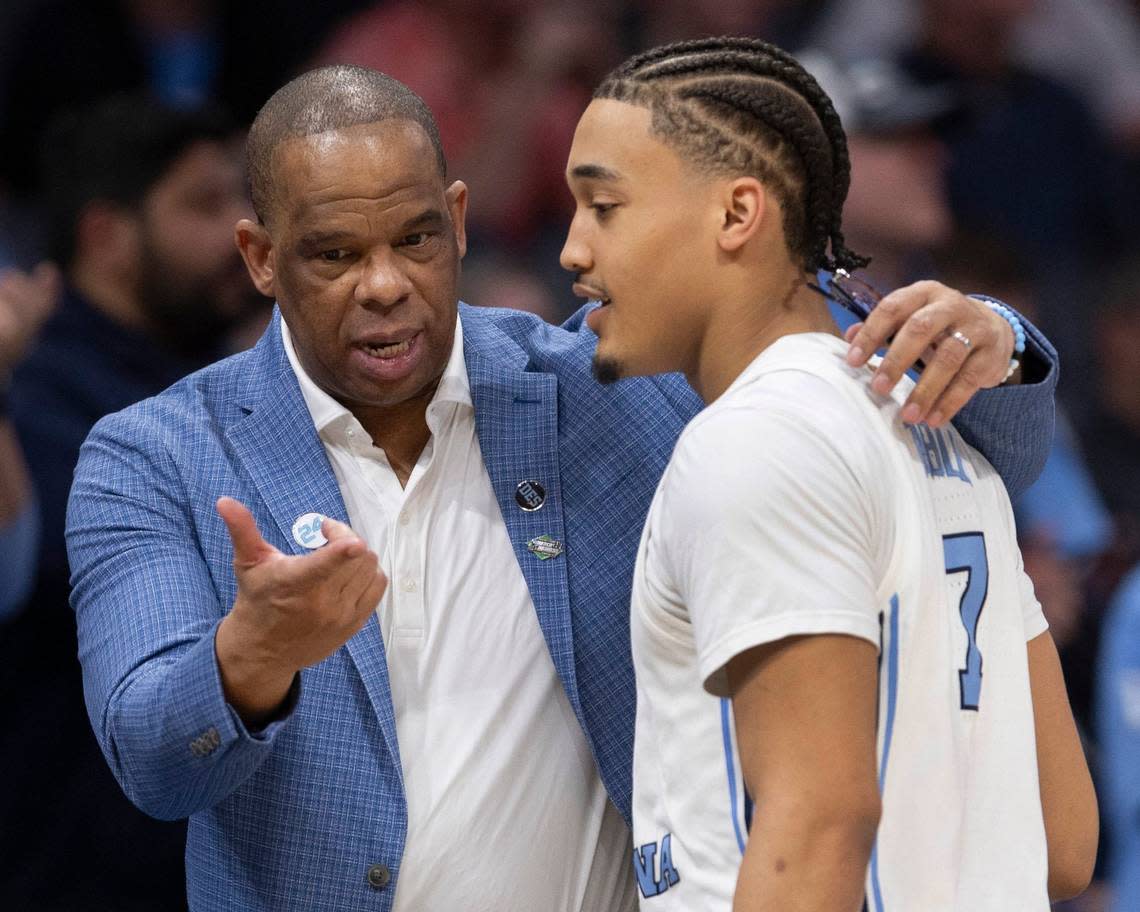 North Carolina coach Hubert Davis talks with Seth Trimble (7) as he comes out the game in the closing minutes of play against Wagner on Thursday, March 21, 2024 during the NCAA Tournament at Spectrum Center in Charlotte, N.C.