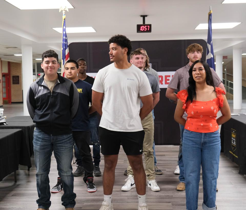 Military enlistee students await taking their oath of enlistment Tuesday at Tascosa High School in Amarillo.