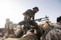 A Yemeni fighter backed by the Saudi-led coalition prepares to fire his weapon during clashes with Houthi rebels on the Kassara frontline near Marib, Yemen, Sunday, June 20, 2021. (AP Photo/Nariman El-Mofty)