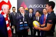 FILE PHOTO: Chinese Premier Li Keqiang laughs with Port Adelaide player Chen Shaoliang from China, during a visit to the team's room before the start of an Australian Football League game at the Sydney Cricket Ground in Sydney