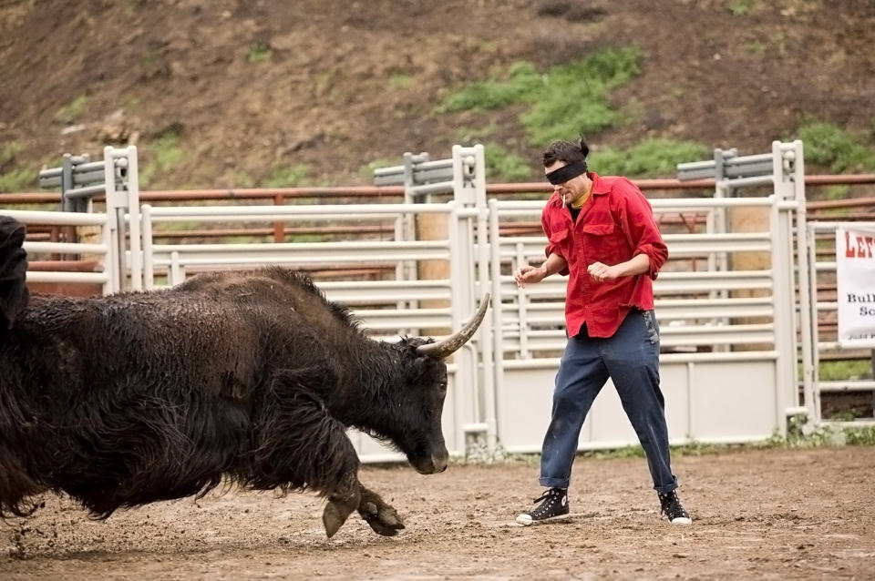 Knoxville braces himself before getting hit by a bull