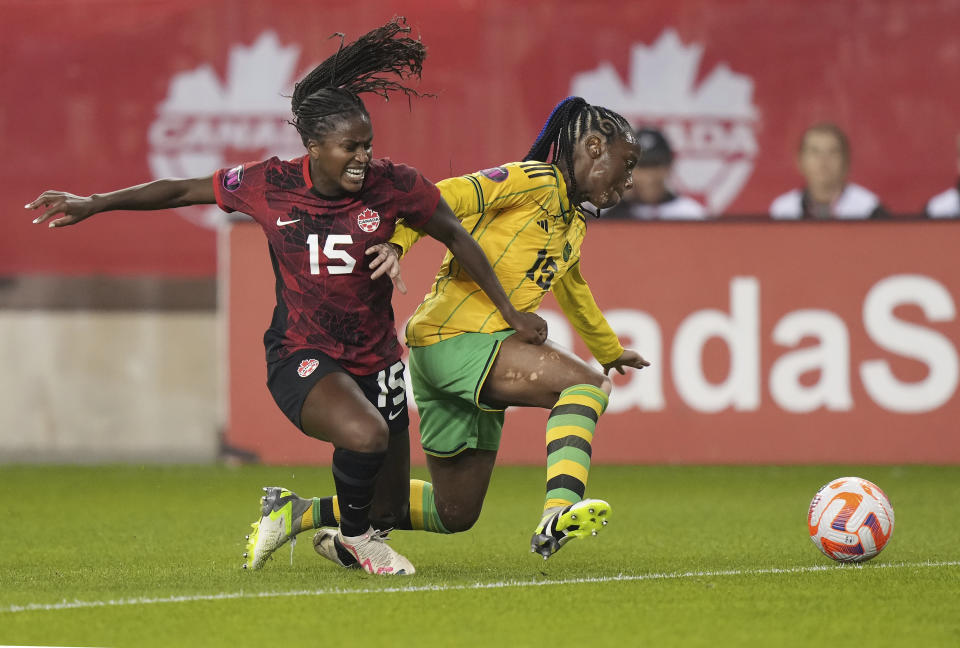 Canada's Nichelle Prince, left, battles Jamaica's Tiffany Cameron for the ball during the first half of a CONCACAF women's championship soccer series match in Toronto on Tuesday, Sept. 26, 2023. (Nathan Denette/The Canadian Press via AP)