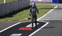 Mercedes driver George Russell of Britain walks back to his pits after he crashed into the track wall during a qualifying session at the Red Bull Ring racetrack in Spielberg, Austria, Friday, July 8, 2022. The Austrian F1 Grand Prix will be held on Sunday July 10, 2022. (Christian Bruna/Pool via AP)