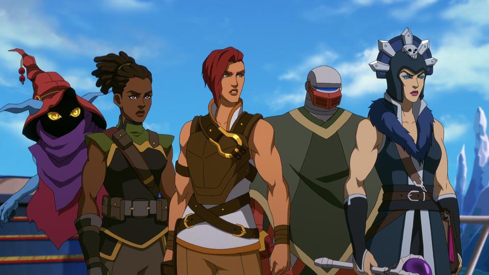 In a CG animated still from Masters of the Universe: Revelation, Orko, Andra, Teela, Roboto and Evil-Lyn stand in a line looking off to their left, serious expressions on their faces. Orko floats mid-air, blue arms and ears visible with face shadowed beneath a red hat and purple scarf. Andra, a dark-skinned female, wears a brown and green military style uniform, hair pulled back. Teela, a light-skinned female with short auburn hair, wears a white top with a brown chest plate and harness. Roboto, a gray robot with a red mouth piece, wears a green cloak. Evil-Lyn, a light-skinned female, wears a blue and silver headpiece with a skull in the center and a blue and brown military style uniform, crystal-orb wand in her right hand at her side. A blue sky and icy landscape are visible behind them.