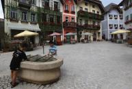 Children play with water in the area of the replica of Austria's UNESCO heritage site, Hallstatt village, in China's southern city of Huizhou in Guangdong province, June 1, 2012.