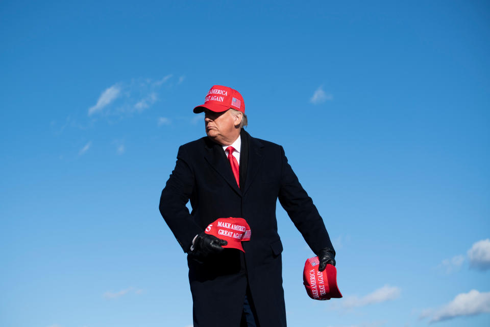 Trump, himself wearing a MAGA hat, throws some of them to his listeners at a rally for his reelection bid in Avoca, Pennsylvania on Nov. 2, 2020. (Photo: BRENDAN SMIALOWSKI via Getty Images)