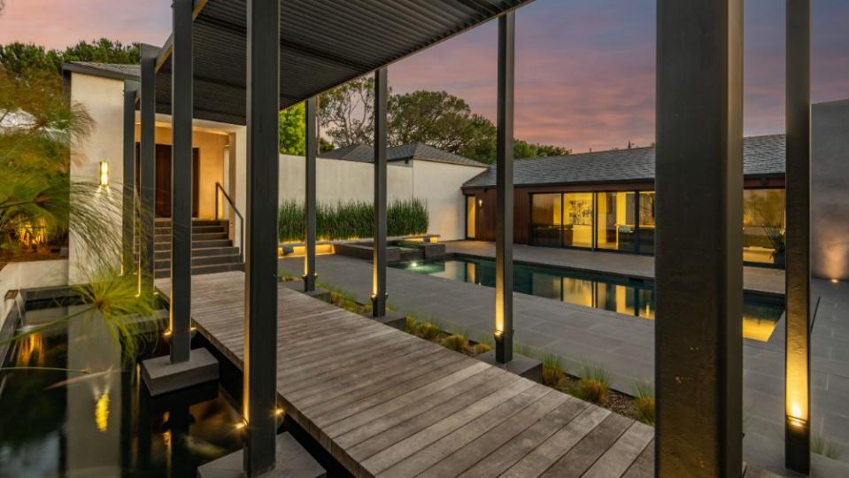 The covered teak walkway with a koi pond. - Credit: Peter McMenamin