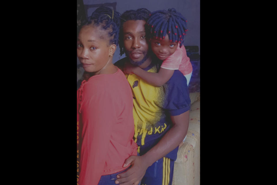 In this handout photo distributed by Mbengue Nyimbilo Crepin, he is pictured with his daughter and wife, who he believes died of dehydration in a desert area near the border between Libyan and Tunisia. Nyimbilo had collapsed on the treacherous desert journey and encouraged his wife and daughter to keep going. He survived but says Matyla Dosso and six-year-old Marie likely did not. (Mbengue Nyimbilo Crepin via AP)