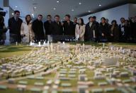 Officials from the G20 Seoul Conference look at miniature models of the Kaesong Industrial Complex (KIC) at the Kaesong Industrial District Management Committee office in Kaesong, a few miles inside North Korea from the heavily fortified border December 19, 2013. North Korea hosted a group of foreign officials and journalists on Thursday in a rare opening of the industrial zone jointly run with the South, a week after the regime executed the powerful uncle of leader Kim Jong Un. North and South Korean officials also held meetings at the Kaesong complex on Thursday to discuss the operations of the factory park, their first contact since the purge of Jang Song Thaek, considered the second-most powerful man in the country. REUTERS/Kim Hong-Ji (NORTH KOREA)