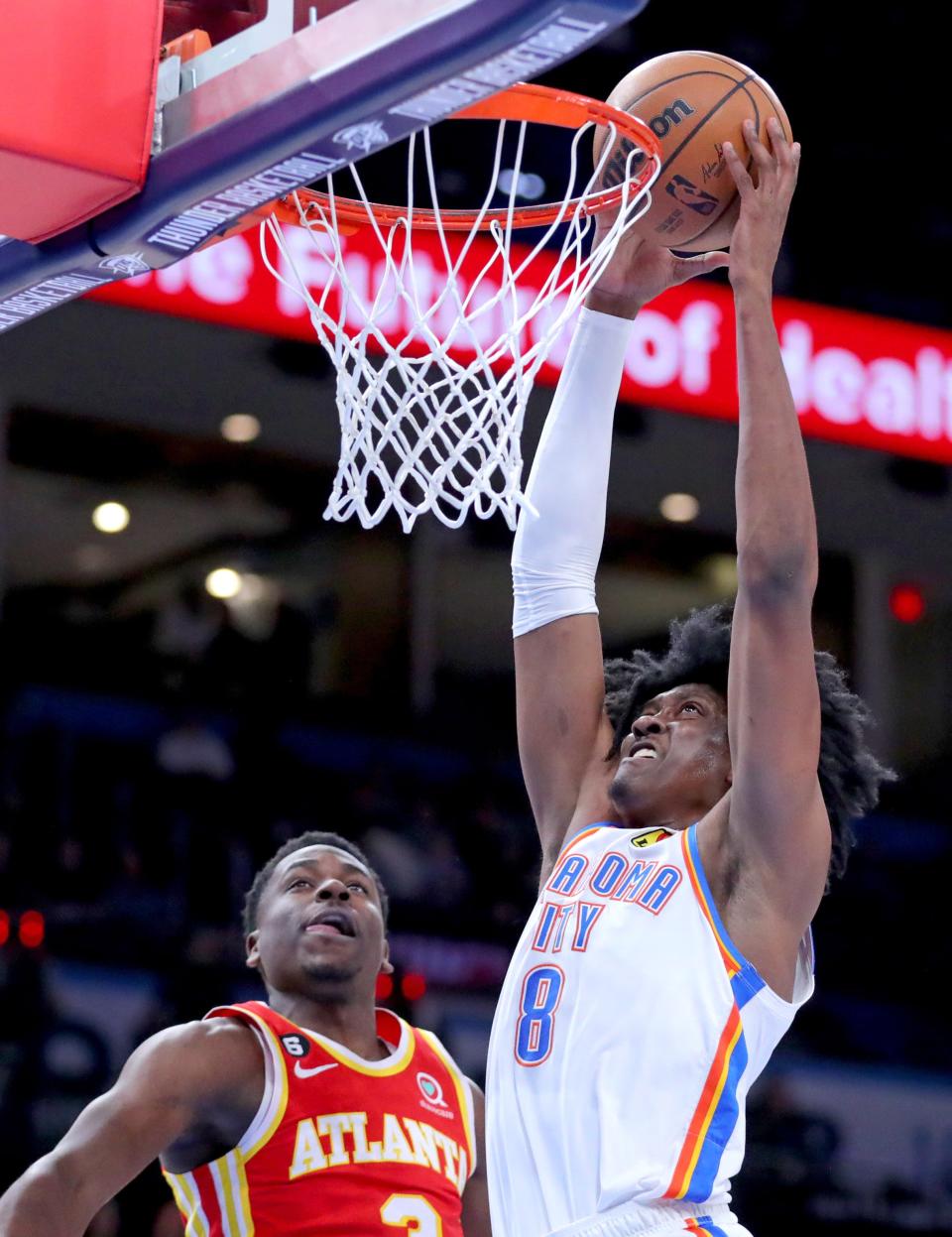 Oklahoma City's Jalen Williams (8) goes p for a basket as Atlanta's Aaron Holiday (3) defends in the fist half during the NBA basketball game between the Oklahoma City Thunder and the Atlanta Hawks at the Paycom Center  in Oklahoma City, Wednesday, Jan.25, 2023. 