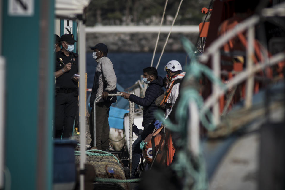 Migrants from Maghreb disembark at Arguineguin port after their rescue in Gran Canaria island, Spain on Wednesday Nov. 25, 2020. Spanish rescue services said Wednesday at least seven people died after a migrant boat carrying more than 30 people hit rocks close to a small port on the Canary Island of Lanzarote. Many of the rescued were taken to the Arguineguín dock on the southwestern coast of Gran Canaria island, where several thousand people of different origin are being kept, some in tents. (AP Photo/Javier Fergo)