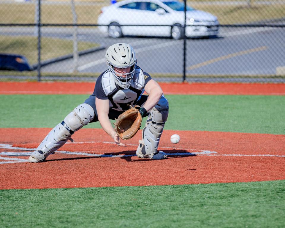 Plymouth North's Mark McKay reaches down to catch the   baseball.