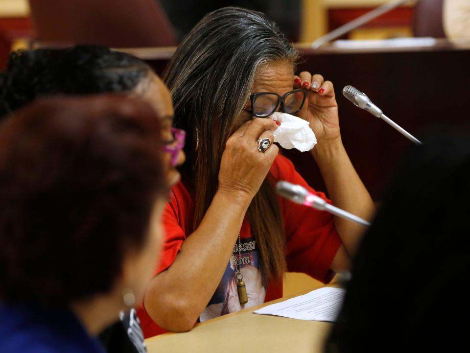 Theresa Smith, right, the mother of Caesar Cruz, who was killed in a confrontation with police, wipes her eyes after testifying about her loss on April 23, 2019, at the Capitol in Sacramento as California lawmakers worked to find common ground between law enforcement groups and reformers intent on adopting first-in-the-nation standards designed to limit fatal shootings by police.